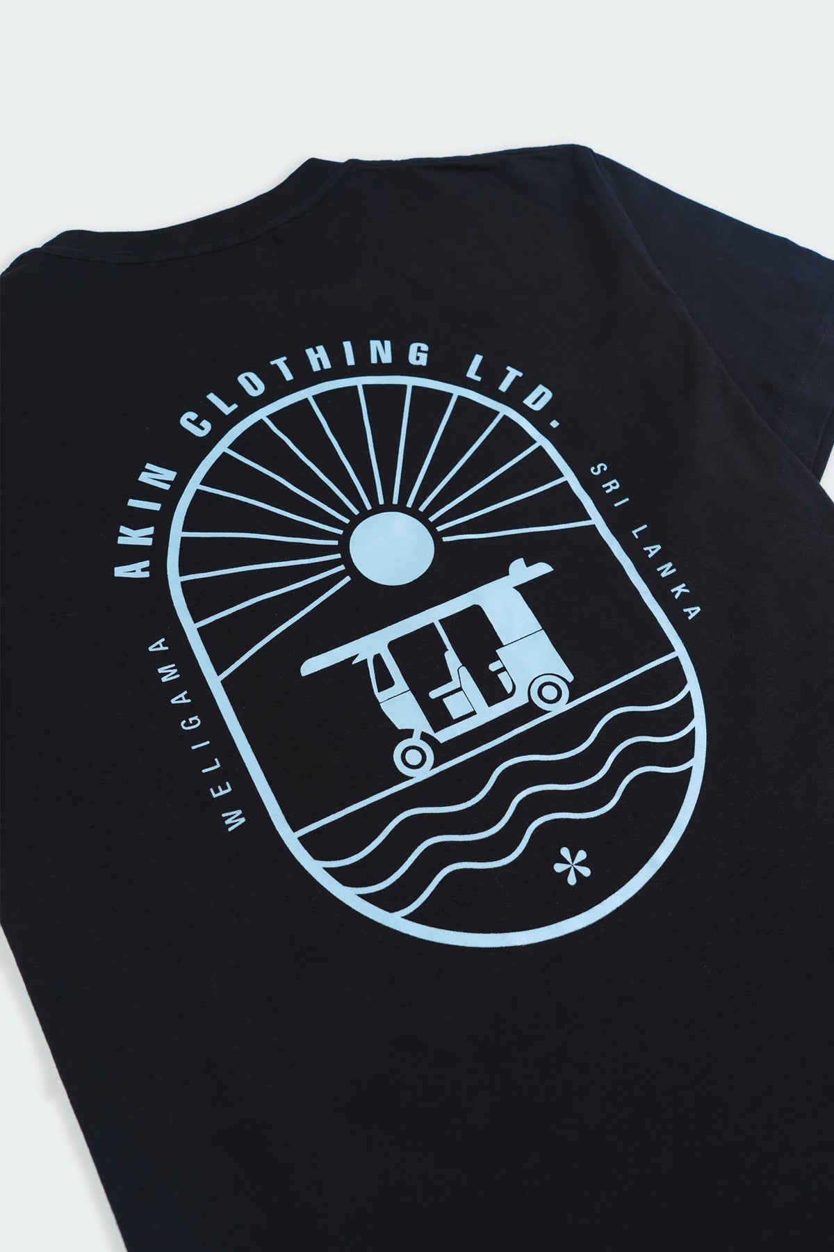 Close-up of Weligama Journey t-shirt back graphic, tuk-tuk and wave oval design with Akin Clothing Ltd text